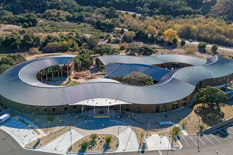 Aerial view of Ohana mental health facility in Monterey, California with wavy silver roof.